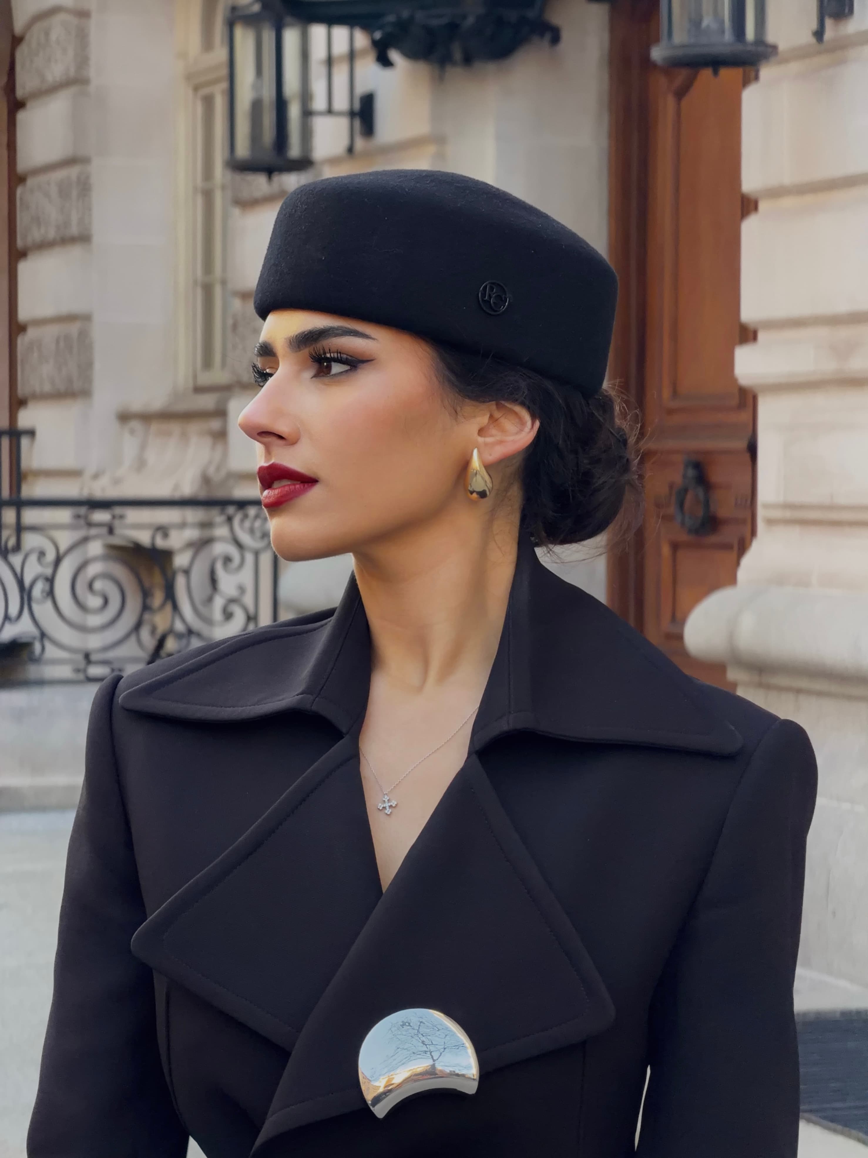 Portrait of Chryssa Handis in a black hat with red lipstick